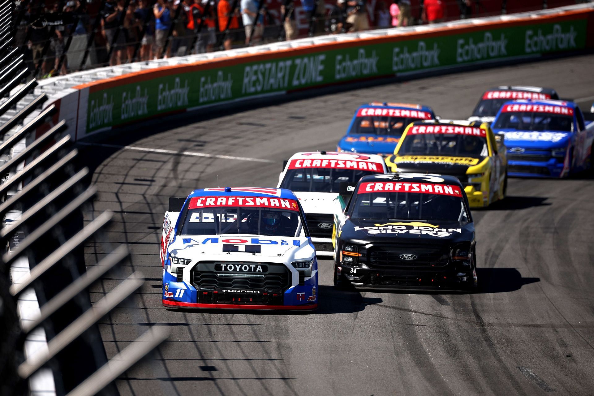 Corey Heim, driver of the #11 Mobil 1 Toyota, and Layne Riggs, driver of the #34 UNC Charlotte Ford, race during the NASCAR Craftsman Truck Series Window World 250 at North Wilkesboro Speedway on May 17, 2025 - Source: Getty